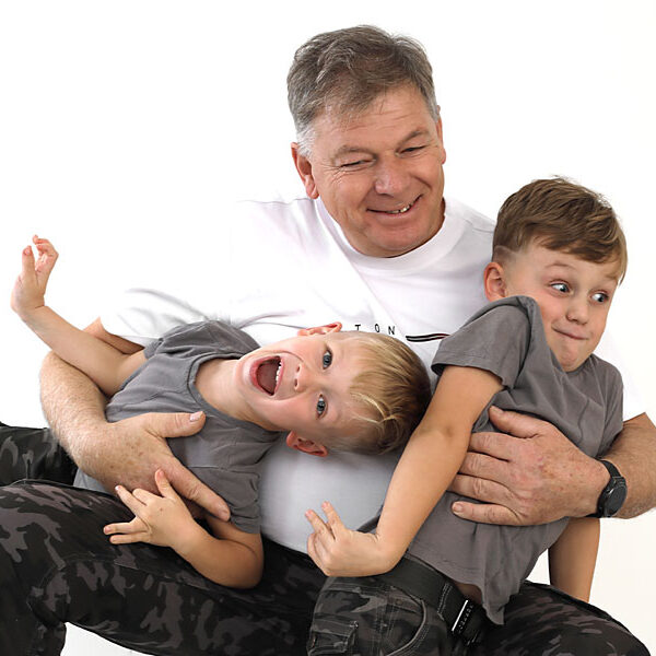 Opa mit Enkeln im Arm.